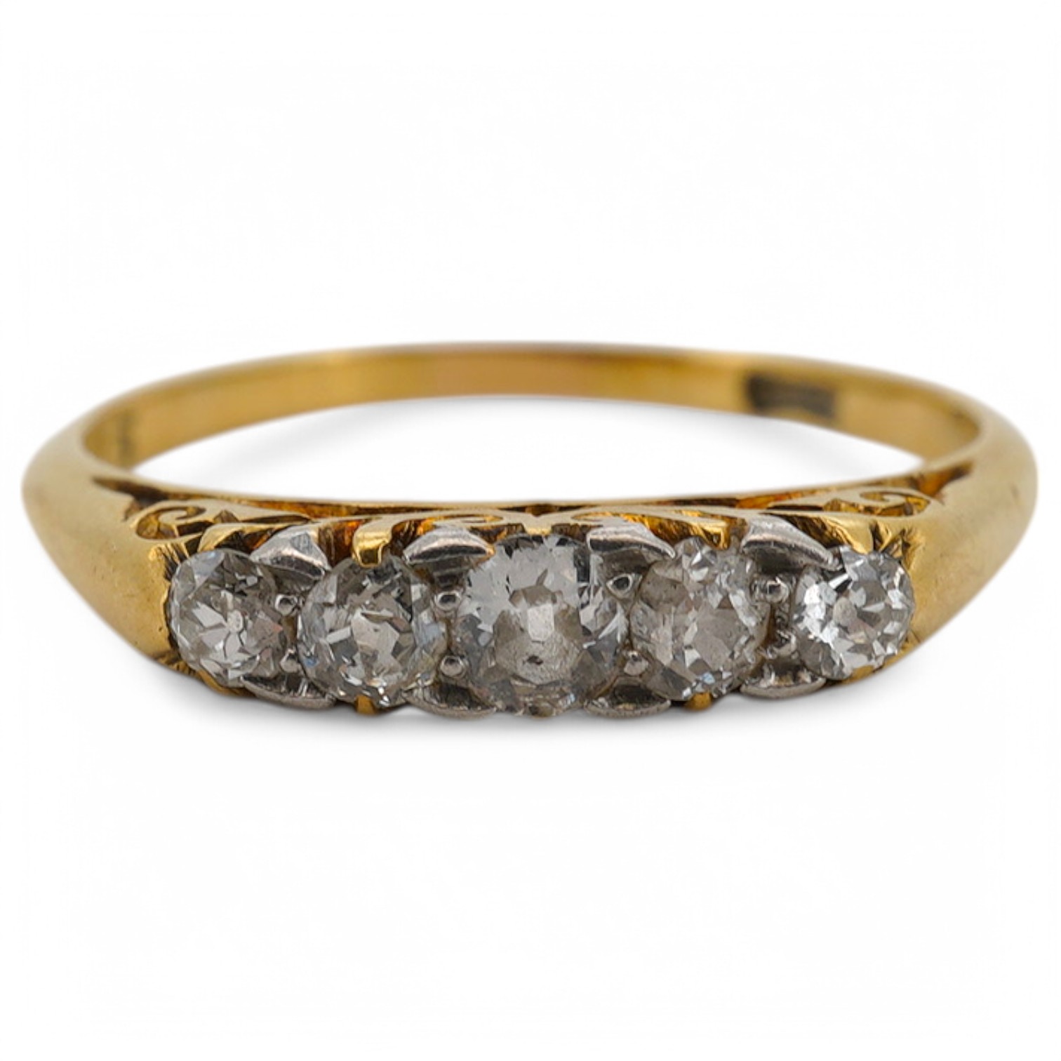 An early 20th century yellow metal and graduated five stone diamond set half hoop ring, size N, gross weight 2 grams. Condition - fair